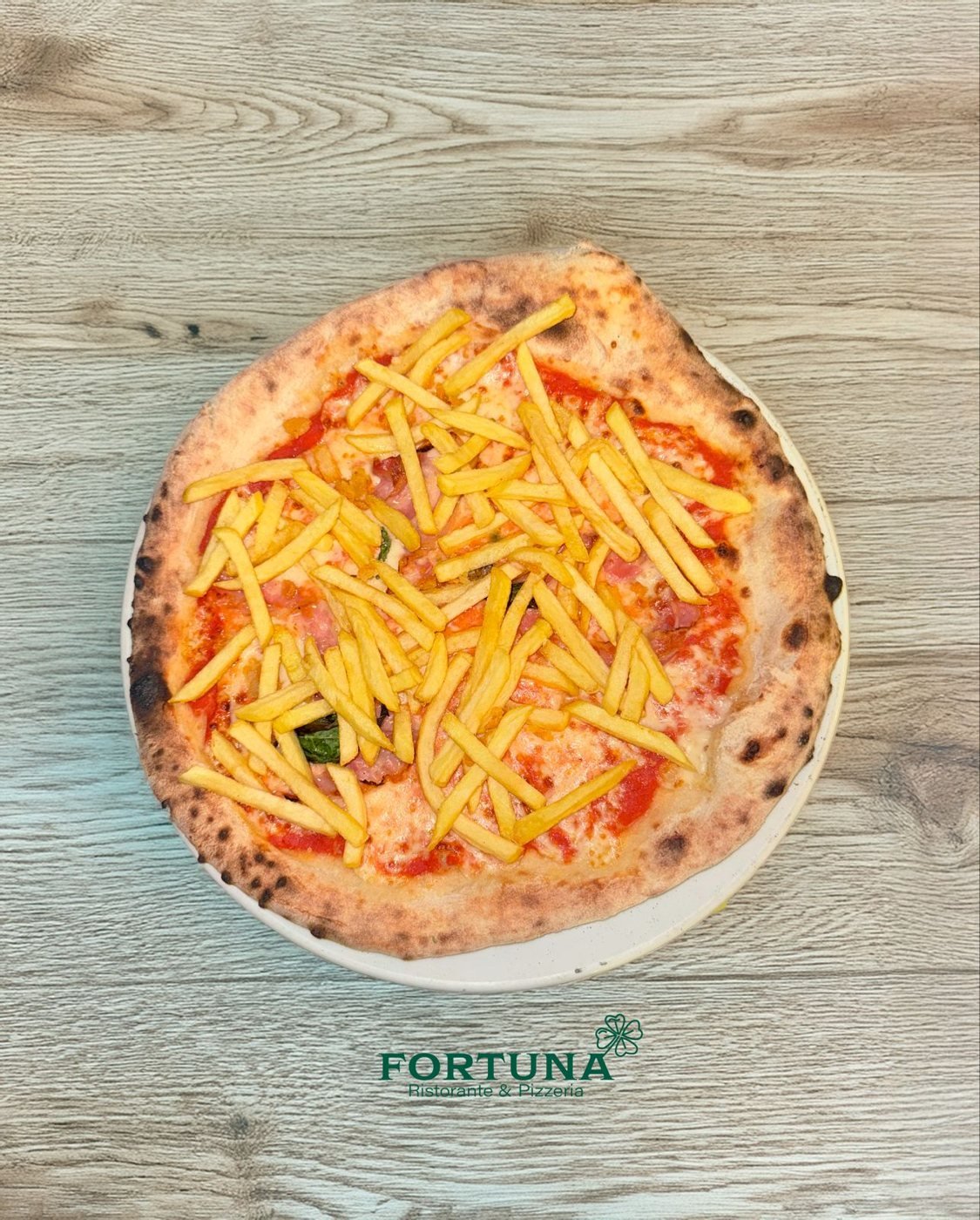 Pizza with ham and fries